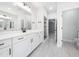 Bright bathroom featuring double sinks, white cabinets, and a large mirror for a modern, spacious feel at 20 Scotland Dr, Youngsville, NC 27596
