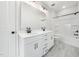 Bright bathroom with double sinks, white cabinets, and a tub/shower combo at 20 Scotland Dr, Youngsville, NC 27596
