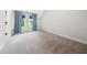 Bright bedroom with carpeted floors, natural light, and blue curtains for a cozy atmosphere at 20 Scotland Dr, Youngsville, NC 27596