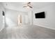 Bright bedroom with ceiling fan, carpet, a TV, and a walk-in closet at 20 Scotland Dr, Youngsville, NC 27596