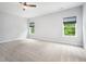 Bright bedroom featuring two windows, neutral paint, and carpet at 20 Scotland Dr, Youngsville, NC 27596