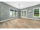 Bright dining area featuring hardwood floors, a modern chandelier, and views of the backyard at 20 Scotland Dr, Youngsville, NC 27596
