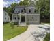 Charming two-story home featuring a covered porch, two-car garage, and a well-manicured lawn at 20 Scotland Dr, Youngsville, NC 27596