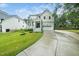 Charming two-story home with a gray exterior, landscaped yard, and attached two-car garage at 20 Scotland Dr, Youngsville, NC 27596