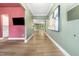 Spacious hallway featuring wood floors, modern lighting, and stylish wall decor at 20 Scotland Dr, Youngsville, NC 27596