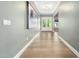 Hallway featuring wood floors, modern lighting, and stylish wall decor at 20 Scotland Dr, Youngsville, NC 27596