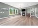 Living room with hardwood floors, a fireplace, a large window with backyard view at 20 Scotland Dr, Youngsville, NC 27596