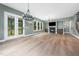 Well-lit living room featuring a fireplace, hardwood flooring, and access to a backyard patio via French doors at 20 Scotland Dr, Youngsville, NC 27596