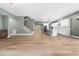 Expansive open-concept living space featuring hardwood floors, a staircase, and a modern kitchen at 20 Scotland Dr, Youngsville, NC 27596