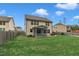 Back exterior view of a beige two-story home with screened porch and fenced yard at 2018 Morehead Hill Ct, Durham, NC 27703
