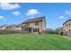 A spacious backyard featuring a well-maintained lawn, a screened porch, and wood fencing at 2018 Morehead Hill Ct, Durham, NC 27703