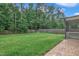 Beautifully landscaped backyard with green lawn, bordered by a wooden fence and mature trees at 2018 Morehead Hill Ct, Durham, NC 27703