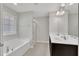 Bright bathroom showcasing a double sink vanity, a large mirror, and a separate shower area at 2018 Morehead Hill Ct, Durham, NC 27703