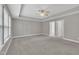 Neutral bedroom with tray ceiling features a large window for natural light and convenient en-suite access at 2018 Morehead Hill Ct, Durham, NC 27703