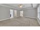 Large bedroom features a tray ceiling and dual doorways leading to a bathroom and hallway at 2018 Morehead Hill Ct, Durham, NC 27703