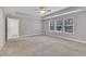 Bright bedroom with neutral paint, carpet, tray ceiling and three windows providing great natural light at 2018 Morehead Hill Ct, Durham, NC 27703