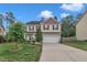 Charming two-story home featuring a two-car garage, well-manicured lawn, and lovely landscaping at 2018 Morehead Hill Ct, Durham, NC 27703