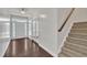 Bright foyer with hardwood floors, staircase, and glass-paneled doors leading to other rooms at 2018 Morehead Hill Ct, Durham, NC 27703