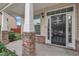Inviting front porch with stone-clad pillars and a stylish black front door with decorative accents at 2018 Morehead Hill Ct, Durham, NC 27703