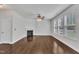 Bright living room with hardwood floors, a fireplace, large windows, and a modern ceiling fan at 2018 Morehead Hill Ct, Durham, NC 27703