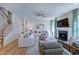 Cozy living room boasts a fireplace, ceiling fan, and comfortable seating arrangement at 204 Hickory Grove St, Sanford, NC 27330