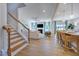 Open-concept space with staircase, open living room, fireplace, kitchen, and dining area at 204 Hickory Grove St, Sanford, NC 27330