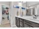 Double vanity bathroom leading to a walk-in closet and tiled shower providing functionality at 208 Cecelia Ct, Cary, NC 27519