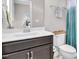 Bright bathroom featuring a white vanity with dark cabinets and a decorative mirror at 208 Cecelia Ct, Cary, NC 27519