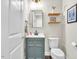 Charming powder room featuring a modern vanity, square mirror, floating shelves, and white toilet at 208 Cecelia Ct, Cary, NC 27519