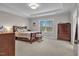 Comfortable bedroom with carpet floors, a tray ceiling and large windows allowing ample light at 208 Cecelia Ct, Cary, NC 27519