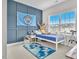 A decorated bedroom featuring blue accent wall, a soccer banner and toys at 208 Cecelia Ct, Cary, NC 27519