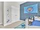 A decorated bedroom featuring blue accent wall and a soccer banner at 208 Cecelia Ct, Cary, NC 27519