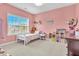 Pink bedroom with a twin bed, window and various toys, offering a playful ambiance at 208 Cecelia Ct, Cary, NC 27519