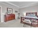 Relaxing bedroom with a dresser, exercise bike and a plush bed providing a serene atmosphere at 208 Cecelia Ct, Cary, NC 27519