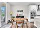 Dining area with round table adjacent to open kitchen and outdoor access at 208 Cecelia Ct, Cary, NC 27519
