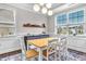 Bright dining area featuring a wooden table, decorative lighting, and large windows at 208 Cecelia Ct, Cary, NC 27519
