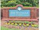 The Peninsula at Amberly community entrance sign featuring vibrant landscaping and a classic brick design at 208 Cecelia Ct, Cary, NC 27519