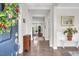 Inviting foyer with hardwood floors, a decorative wreath, and a view into the home's interior at 208 Cecelia Ct, Cary, NC 27519