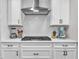 Contemporary kitchen featuring white cabinets, quartz countertops, subway tile backsplash, and stainless steel appliances at 208 Cecelia Ct, Cary, NC 27519