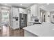 Bright kitchen with stainless steel appliances, white cabinets and view to breakfast nook at 208 Cecelia Ct, Cary, NC 27519