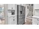 Modern kitchen with stainless steel refrigerator and white cabinets offers ample storage at 208 Cecelia Ct, Cary, NC 27519