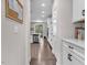 Open kitchen layout with white cabinets, stainless appliances, and hardwood floors leading to an eat-in area at 208 Cecelia Ct, Cary, NC 27519