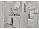 Functional laundry room with modern washer, dryer, and shelving for storage at 208 Cecelia Ct, Cary, NC 27519