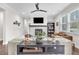 Inviting living room features a modern fireplace, a ceiling fan and plenty of natural light at 208 Cecelia Ct, Cary, NC 27519