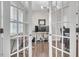 Well-lit office space with hardwood floors, multiple computer monitors, and a modern chandelier at 208 Cecelia Ct, Cary, NC 27519