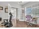 Bright office area with hardwood floors, natural light, and a view into the dining room at 208 Cecelia Ct, Cary, NC 27519