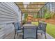 Patio with a shaded dining area providing a cozy outdoor space next to the home and a play structure at 208 Cecelia Ct, Cary, NC 27519