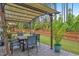 Stone patio with a shaded dining area, a lush lawn, and an enchanting play structure for outdoor enjoyment at 208 Cecelia Ct, Cary, NC 27519