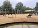 Community playground with swings, slides, climbing structures, and seating areas for families to enjoy at 208 Cecelia Ct, Cary, NC 27519