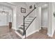 Elegant staircase featuring hardwood floors, white risers and a dark wood banister at 208 Cecelia Ct, Cary, NC 27519